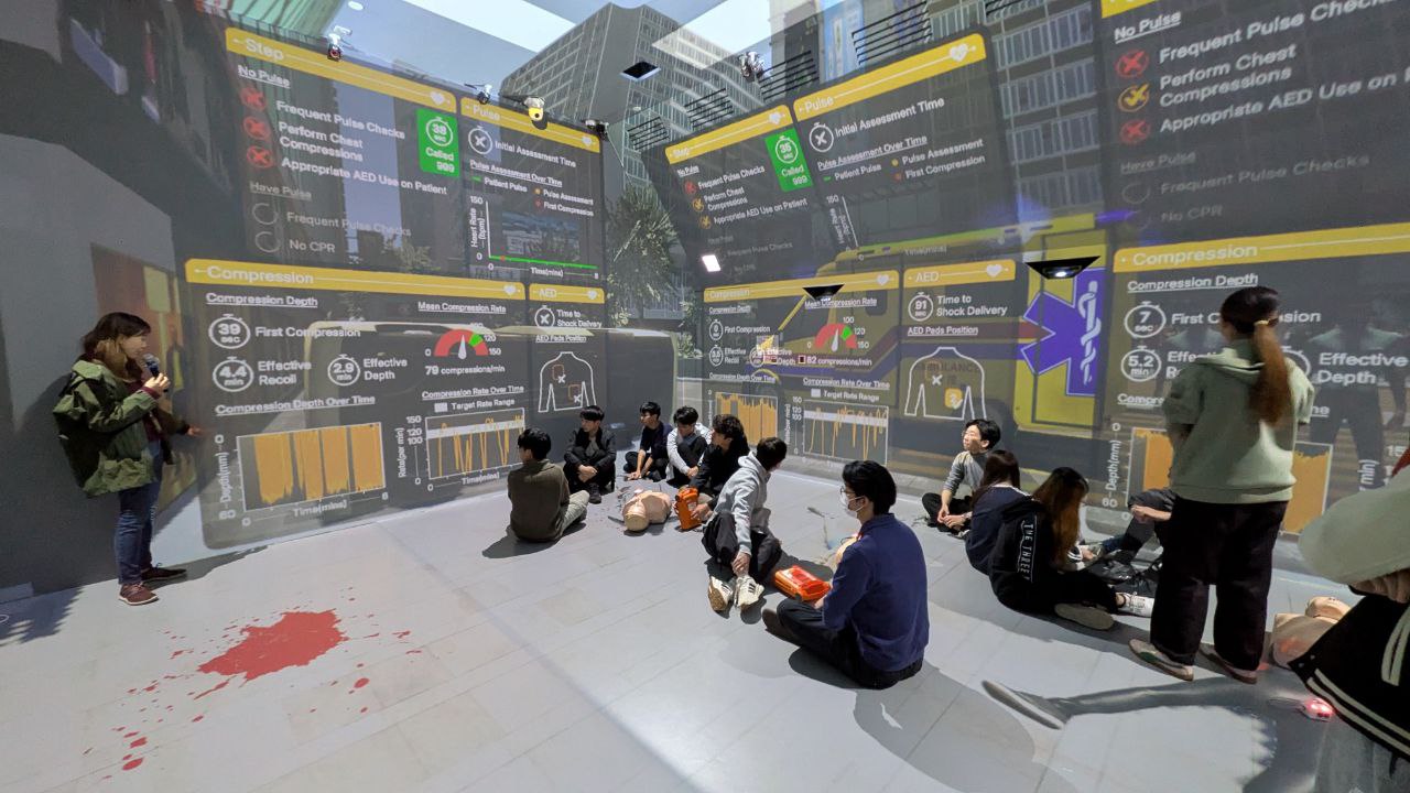 Students during debrief, looking at projection wall